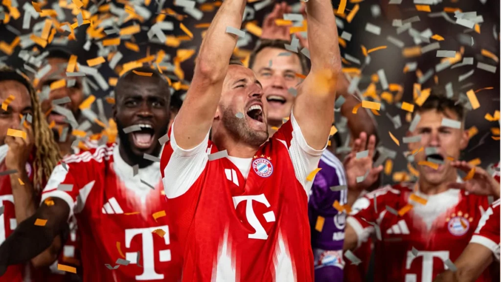Harry Kane celebrating with Bayern Munich teammates in football smile transformation discussion