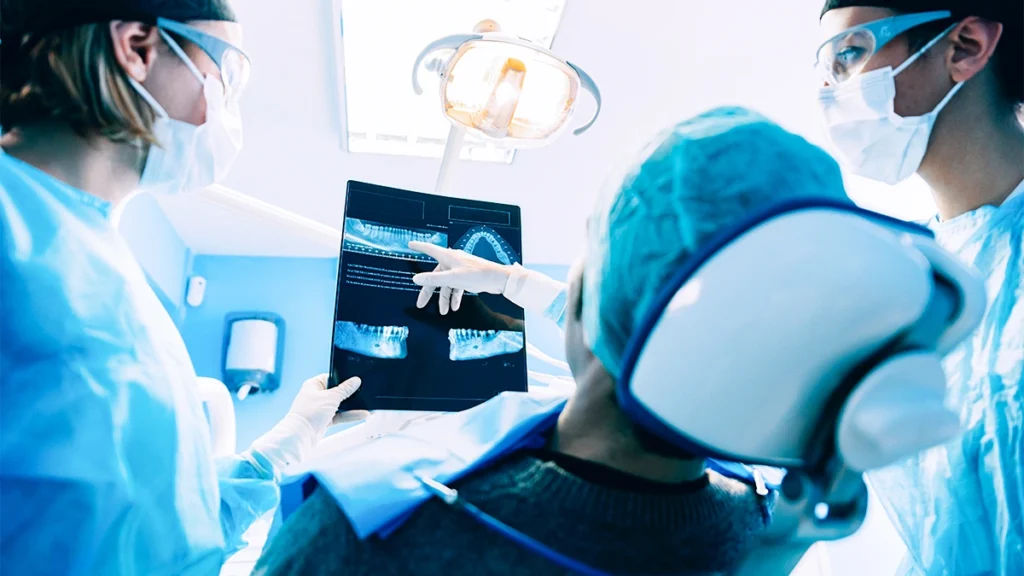 Dentists reviewing dental X-rays before recommending dental implants