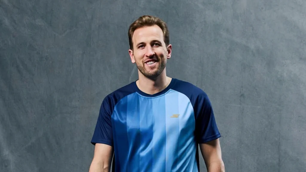 Harry Kane smiling in sportswear showing athlete public image and confidence