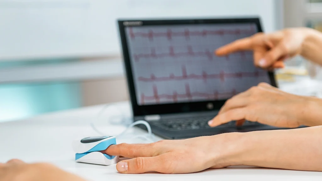 Patient’s heart rhythm and oxygen levels monitored before dental implant treatment