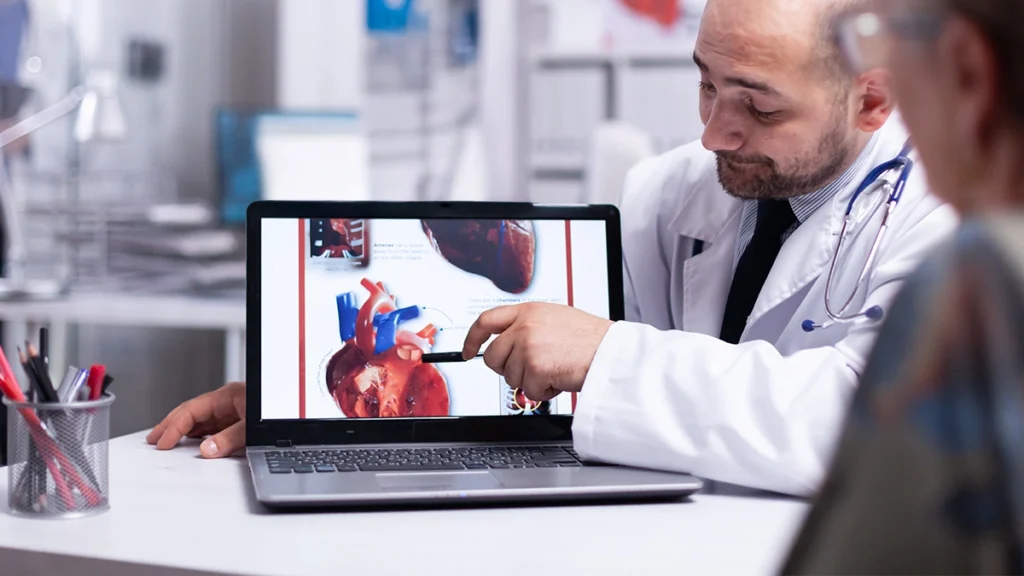 Cardiologist discussing heart health and dental implant treatment with a patient