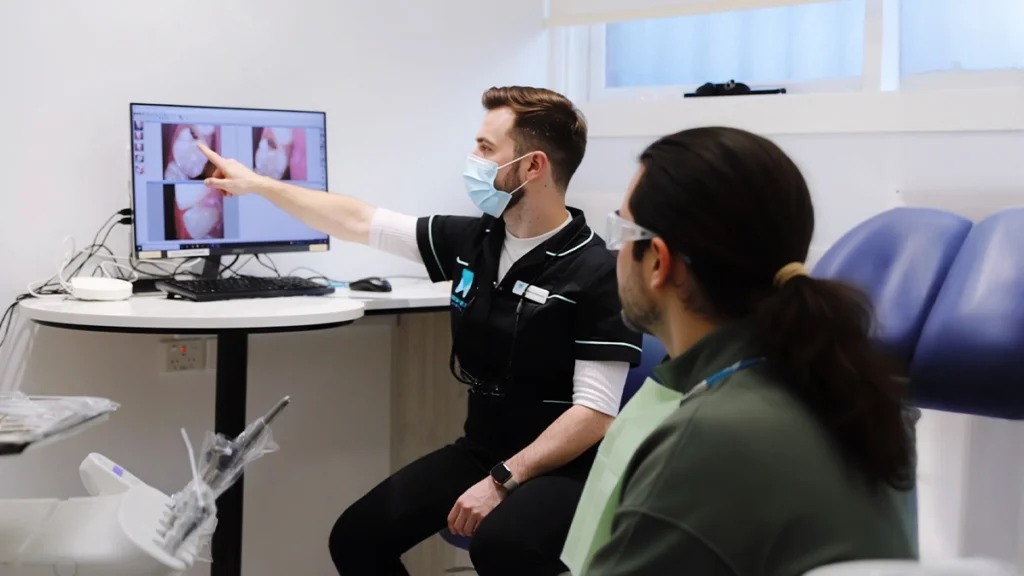 Dentist explaining implant treatment options to a patient with bruxism
