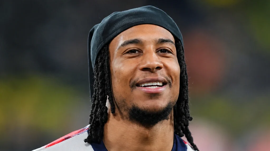 Michael Olise smiling during a football match appearance