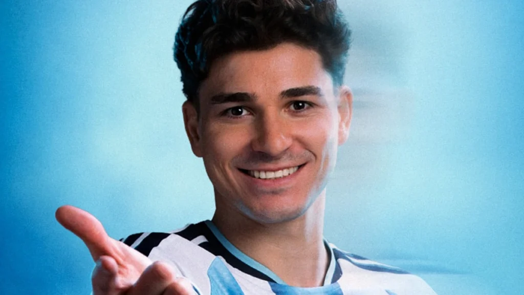 Julián Álvarez smiling in an Argentina football shirt