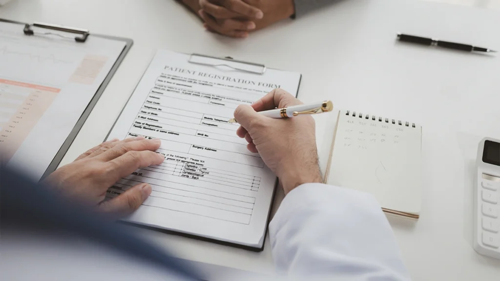 Dentist reviewing a patient’s medical history before dental implant surgery while taking blood thinners