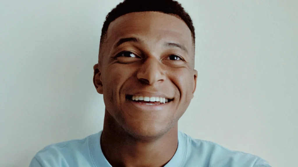 Kylian Mbappé smiling in a portrait highlighting dental health and athlete confidence