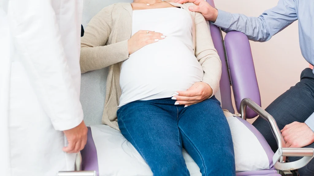 Pregnant patient receiving a dental consultation during pregnancy