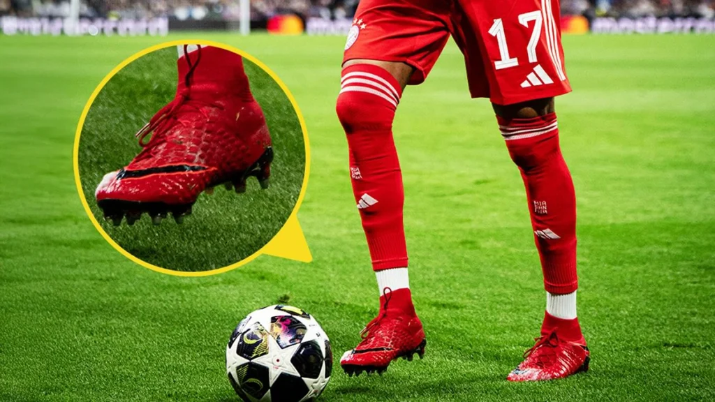 Michael Olise wearing red football boots during a match