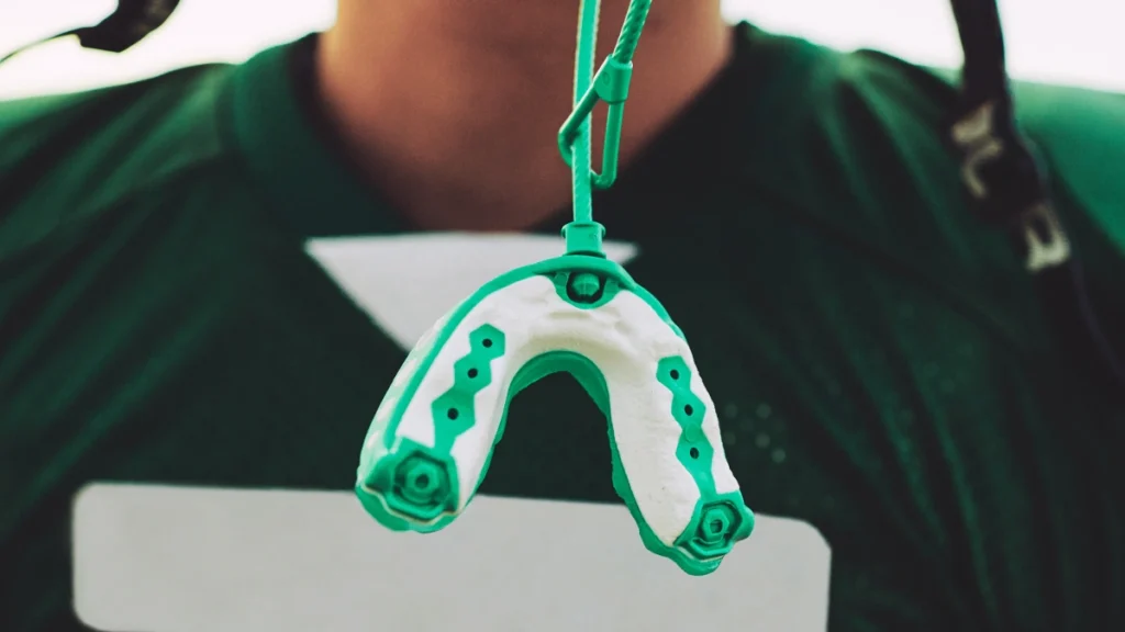 Athlete wearing a custom sports mouthguard for dental protection
