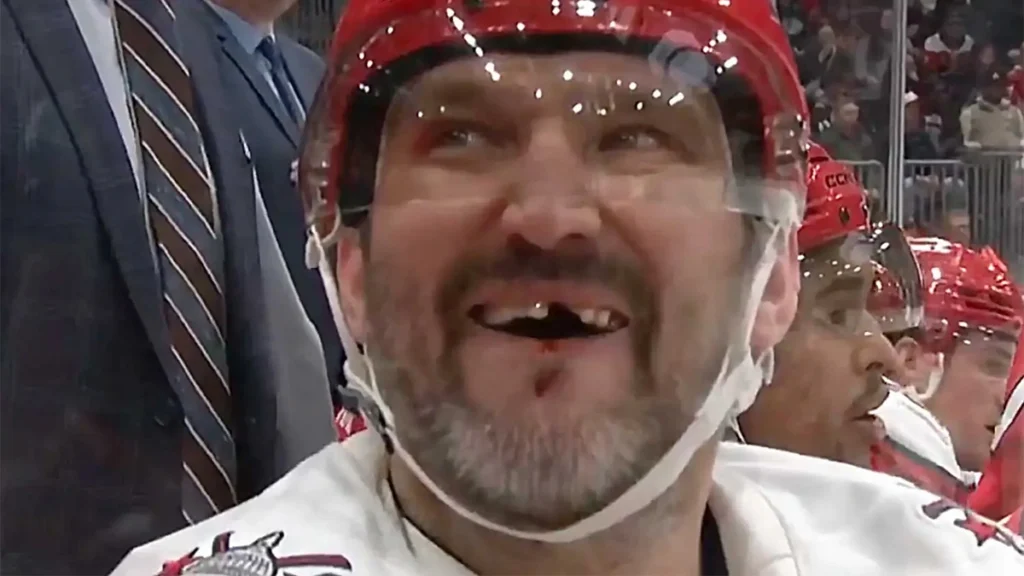 Alexander Ovechkin smiling with visible missing front teeth after a game