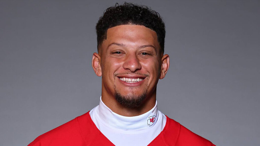 Patrick Mahomes smiling in a Kansas City Chiefs uniform, highlighting athlete confidence and public image.