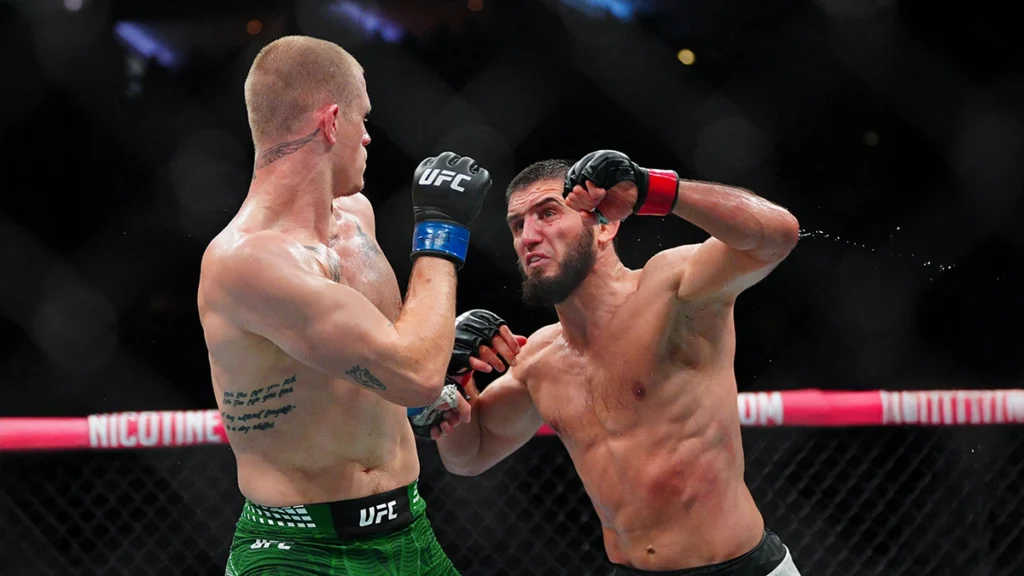 UFC fighters exchanging strikes during an MMA fight while using mouthguards to protect their teeth