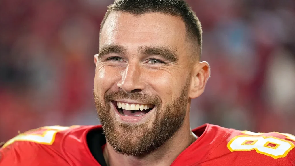 Travis Kelce Smile during a public appearance, highlighting his teeth and confident smile as a professional NFL athlete.