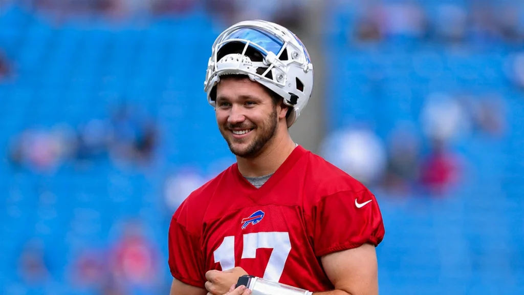 Josh Allen smiling during Buffalo Bills practice in his football uniform